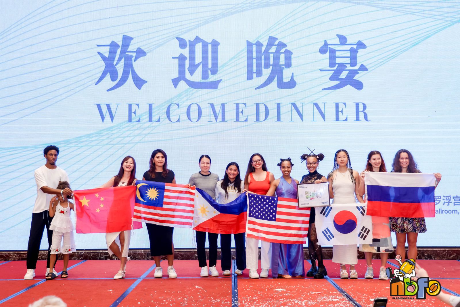 Asia Smiley at an international gathering surrounded by multiple country flags