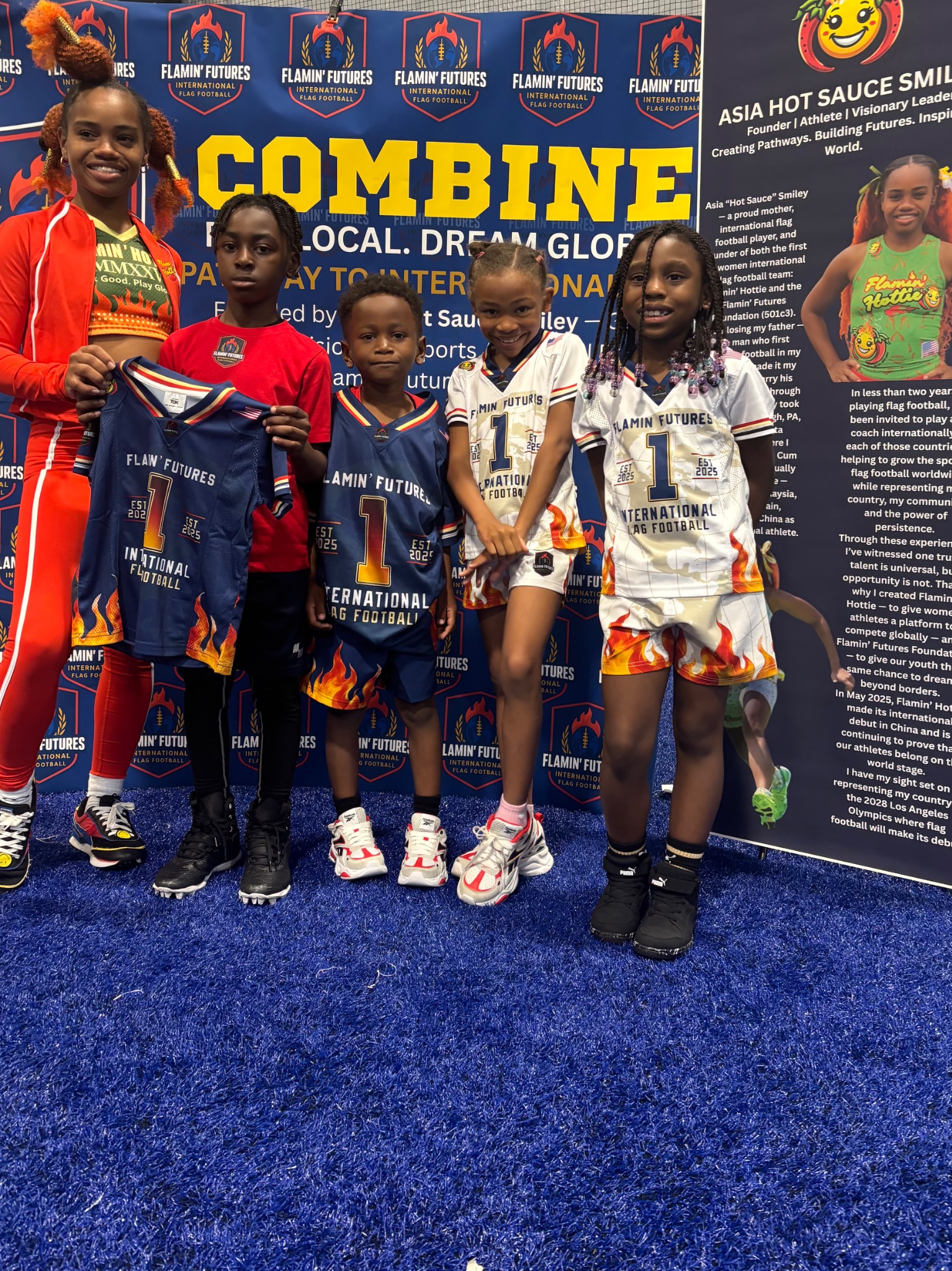 Asia Smiley with four young athletes holding Flamin Futures uniforms